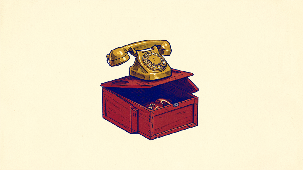 Golden rotary telephone rests on an open wooden chest with brass receiver
